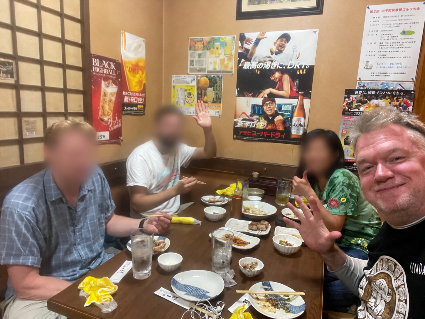 The monk and a fieldwork group sharing dinner; other diners’ faces blurred